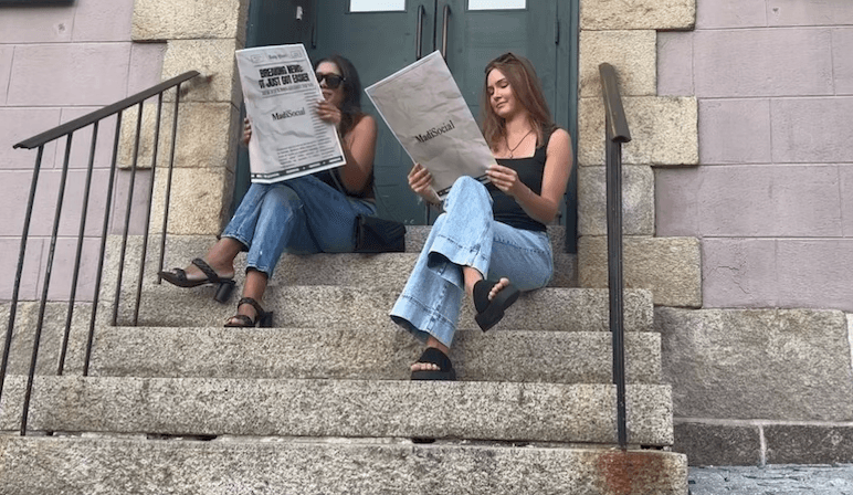 Founder holding a newspaper